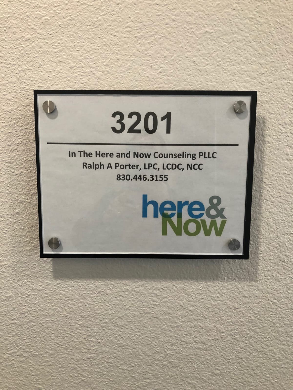 Door plaque for Suite 3201 reading In The Here and Now Counseling PLLC, Ralph A Porter, LPC, LCDC, NCC.